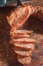 Sliced Ã¢â¬â¹Ã¢â¬â¹smoked calabrese sausage in a wooden table,copy space